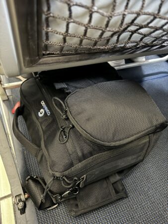 Conmigo ULTI Messenger bag on airplane