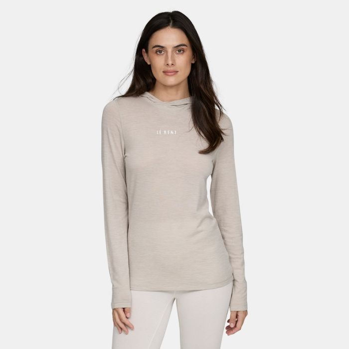 Model wearing Lé Bent Women’s Featherweight in natural colorHooded LS Crew