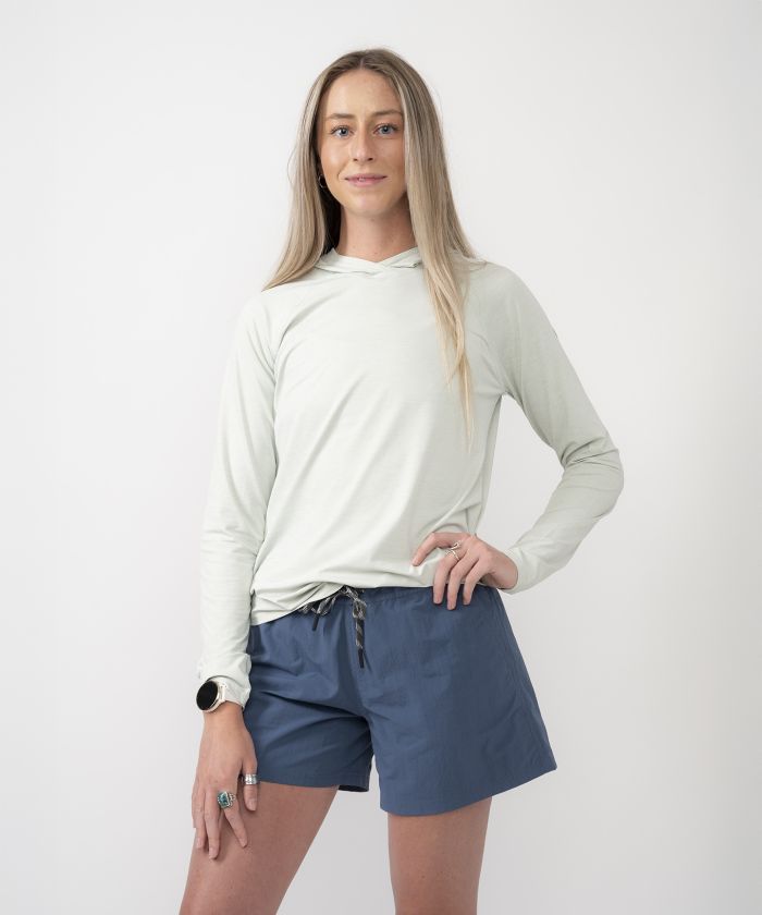 Woman wearing Strafe Sun Hoodie in surf color