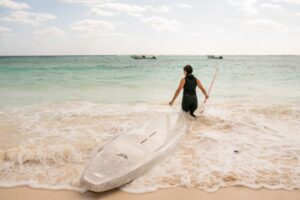 paddle boarder wearing a bare Exowear Hooded Vest