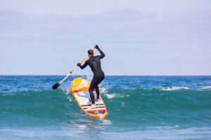 person standing on a paddle board